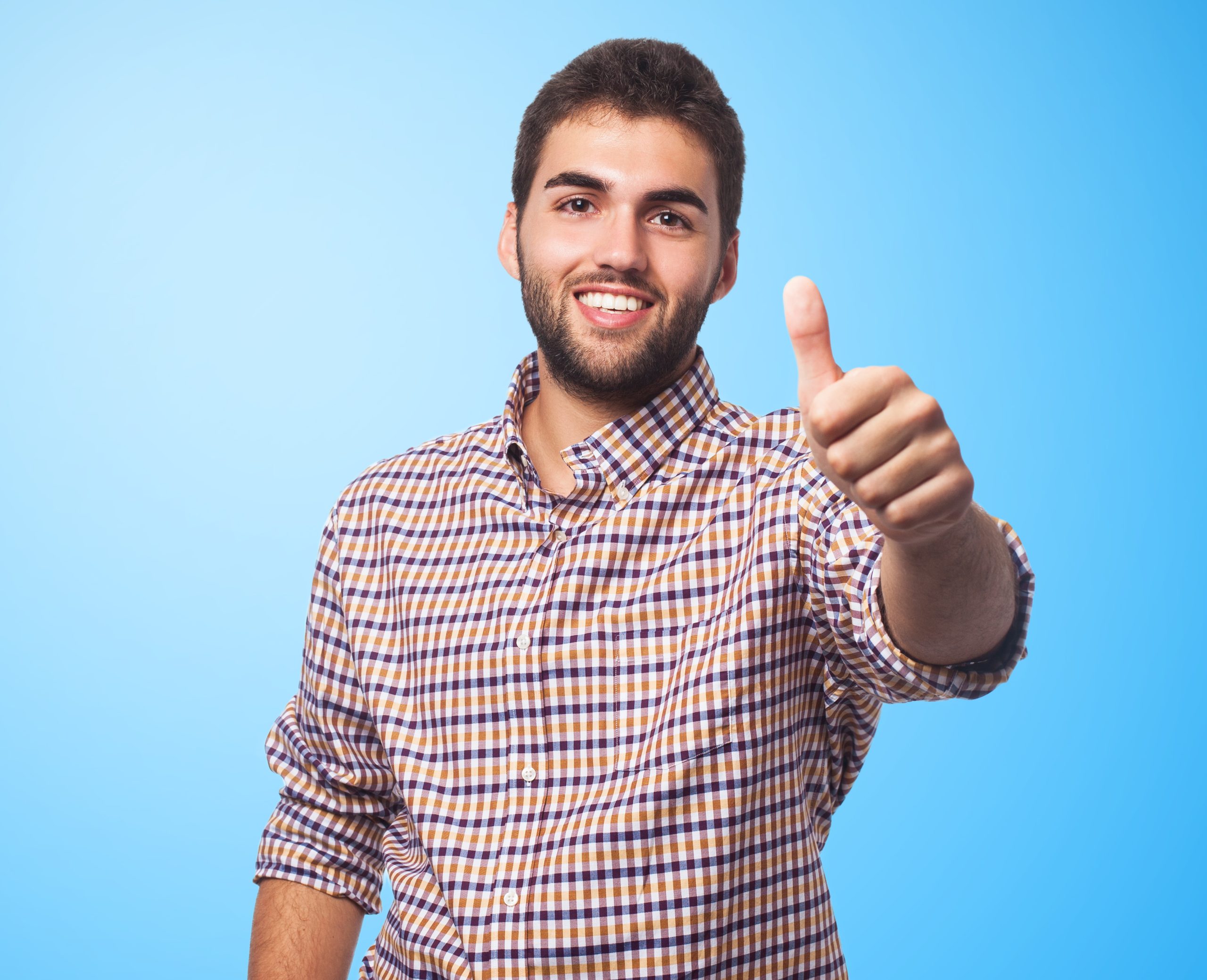 portrait of a handsome young man with thumb up